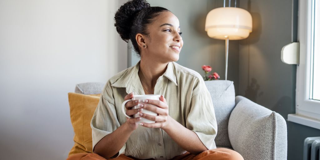 Woman looking happy with a cup of coffee