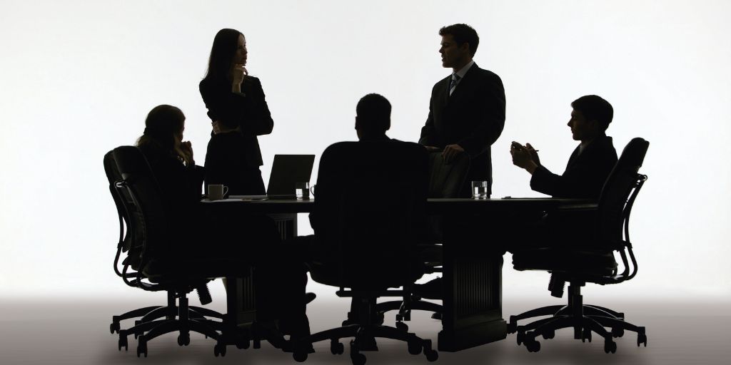 a group of people at a meeting table having a discussion